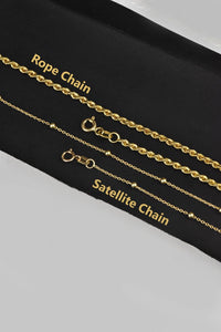 a set of three gold chain bracelets